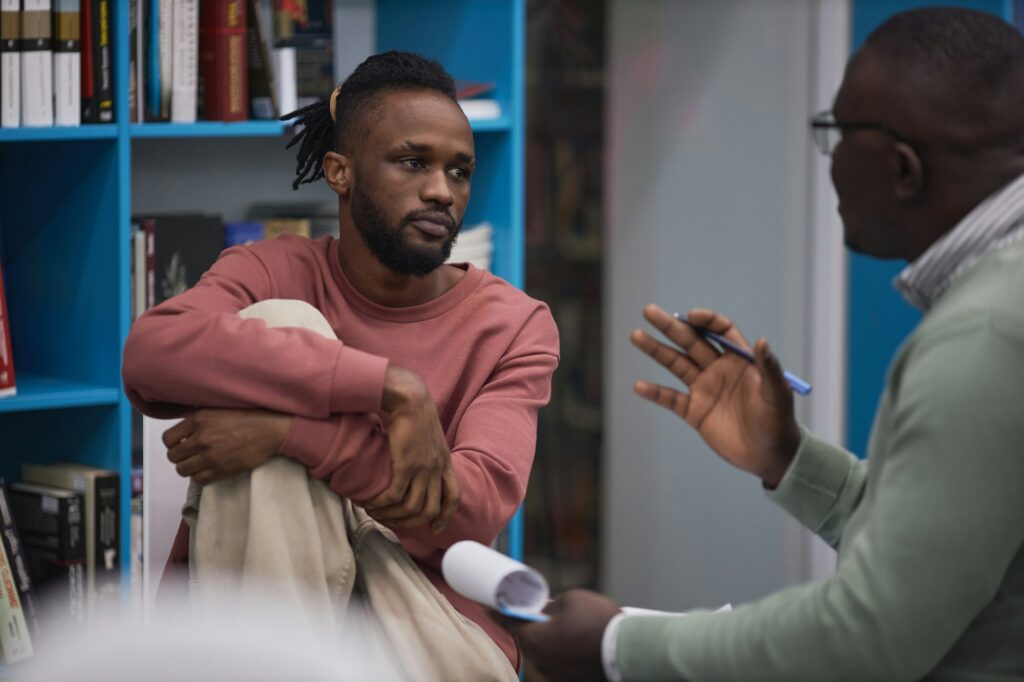 Black student listening to mental health therapist